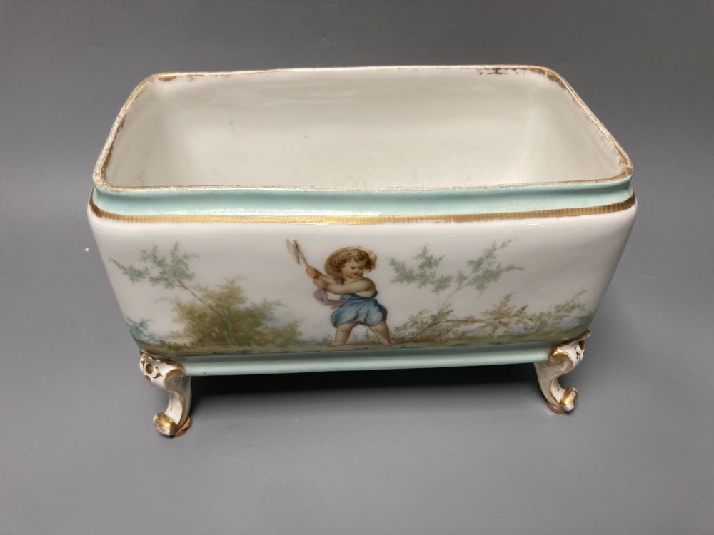 A set of three 19th century French porcelain jardinieres, painted with classical children playing, tallest 14.5cm width 22cm